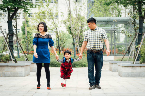istock Couple walking with their daughter in the park 964201838