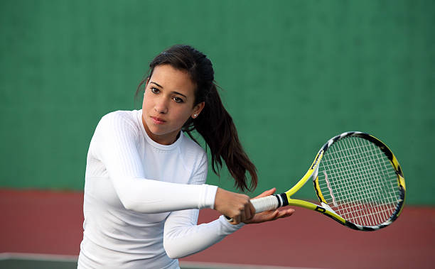 Girl playing tennis stock photo