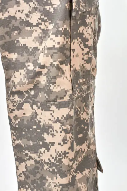 Military trouser-leg, close up. White isolated background.