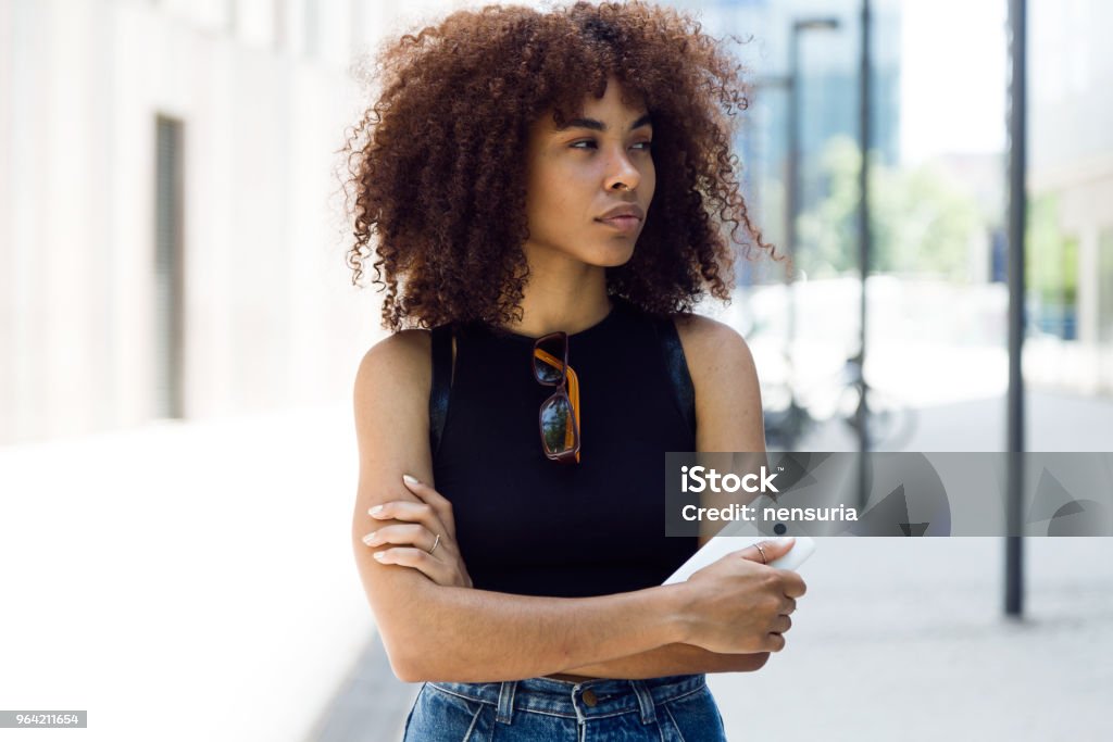 Beautiful young woman looking sideways in the street. Portrait of beautiful young woman looking sideways in the street. Adult Stock Photo