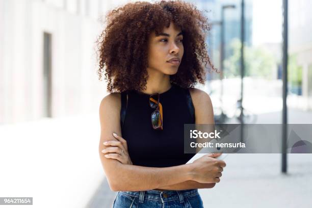 Beautiful Young Woman Looking Sideways In The Street Stock Photo - Download Image Now