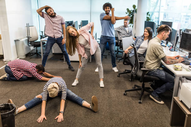 istock Group of programmers exercising on a break in the office. 964212726