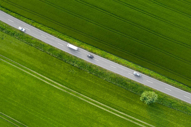 istock Road through agricultural area, aerial view 964213360