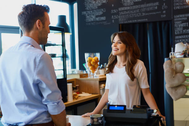 istock Young barista, waitress talking with customer in cafe 964213402