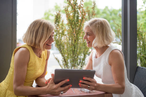 istock Female twins in a cafe 964213638