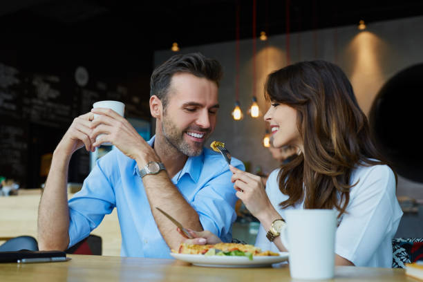 istock Happy couple at restaurant eating lunch, having fun 964215728