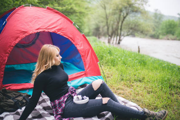 istock girl hiker in a tent and holding a cup 964215758