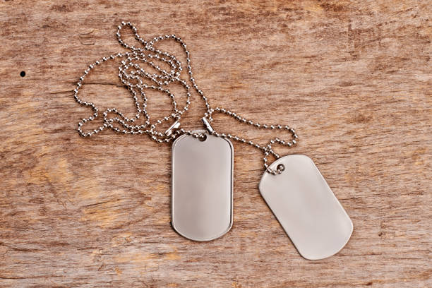 istock Dog tags on wood, close up. 964216130