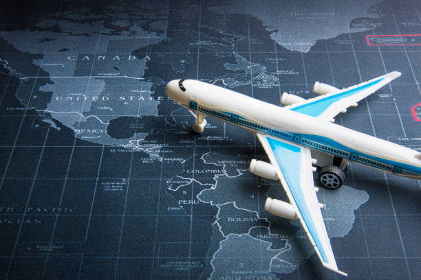istock Passenger plane on the world map.Business transportation system concept. 964216536