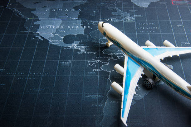 istock Passenger plane on the world map.Business transportation system concept. 964216630