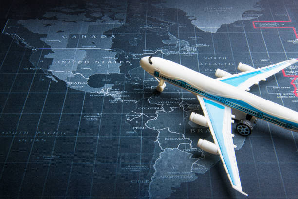 istock Passenger plane on the world map.Business transportation system concept. 964216670