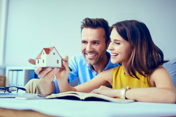 istock Happy couple planning new home design 964217156