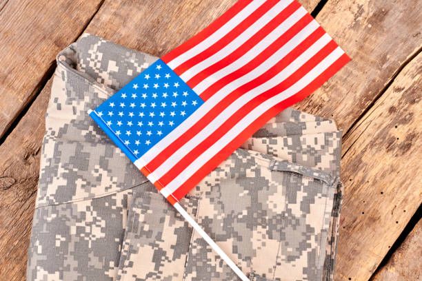 istock Camouflage clothes and us flag. 964219740