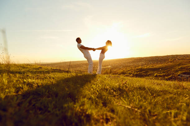 istock Happy couple on a beautiful sunset in nature 964220076
