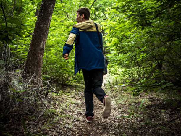 istock scary guy running in the dark forest 964223724