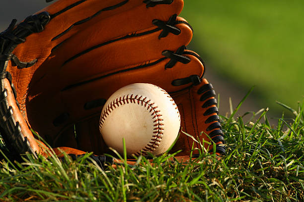 istock Baseball and glove on the grass 96422636