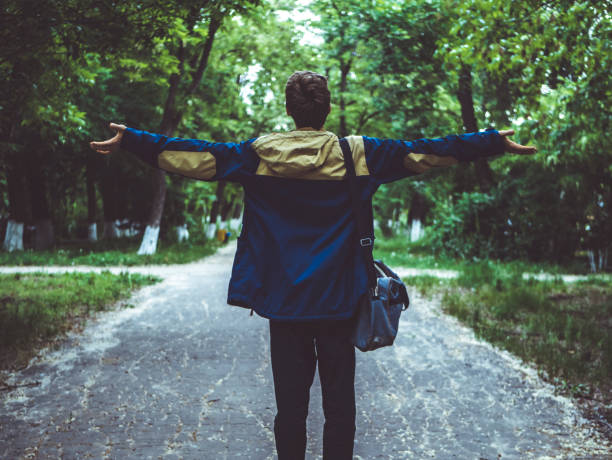 istock young man dreaming and waving hands on the alley 964226790