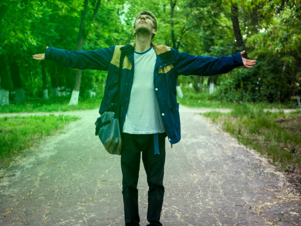 istock young man dreaming and waving hands on the alley 964226796