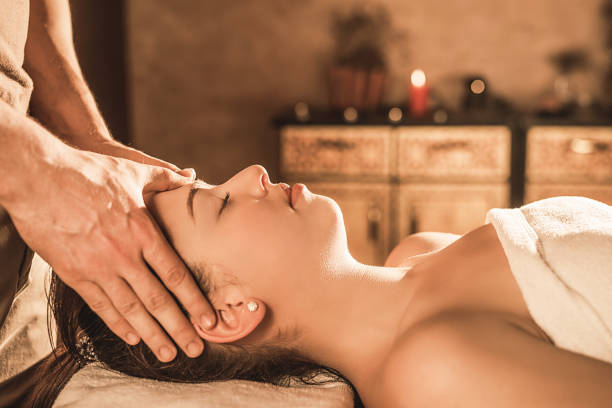 istock Relaxed young woman receiving a head massage. 964229672