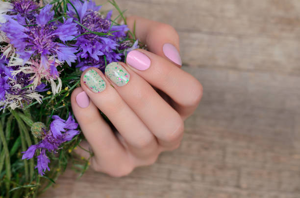 istock Female hands with pink nail design 964229982