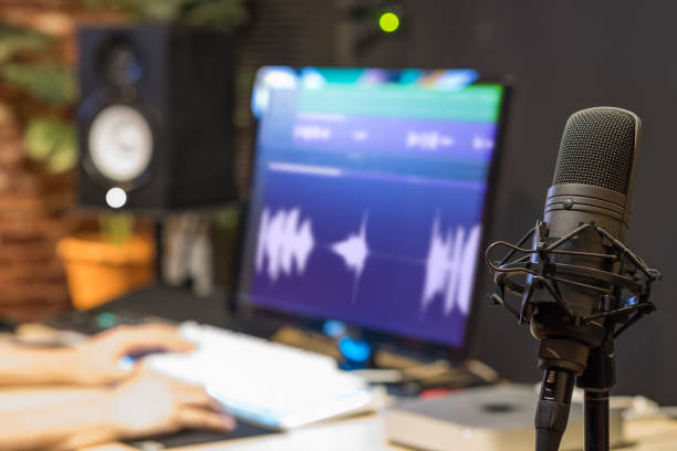 istock condenser microphone on sound engineer hands editing voice waveform background in broadcasting studio 964232688
