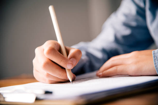 istock Closeup of woman's hand writing on paper 964233406
