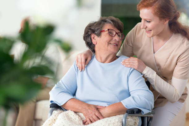 istock Friendly relationship between smiling nurse and happy disabled grandmother 964234144