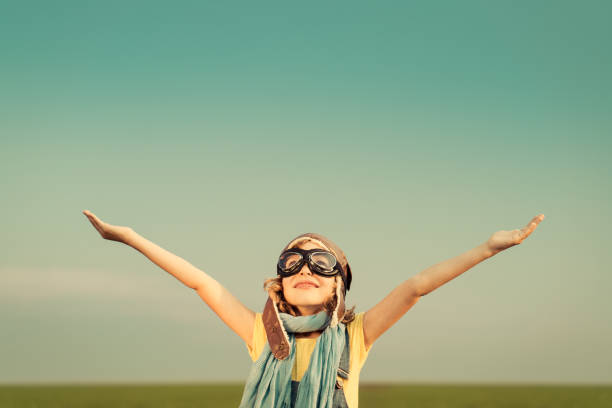 istock Happy kid playing with airplane outdoors 964236510