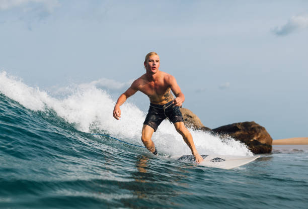 istock guy swims on the surf on the wave 964237062