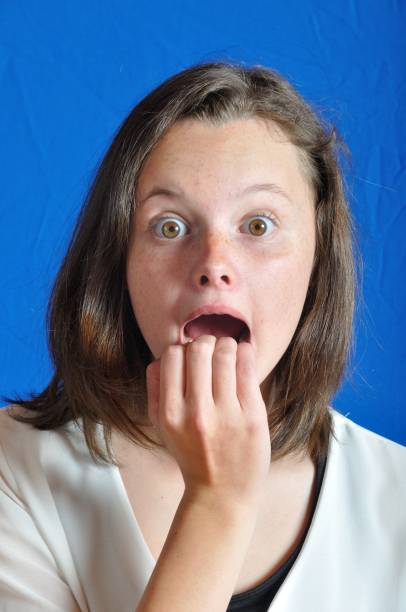 istock Scared teen on blue background 964241860