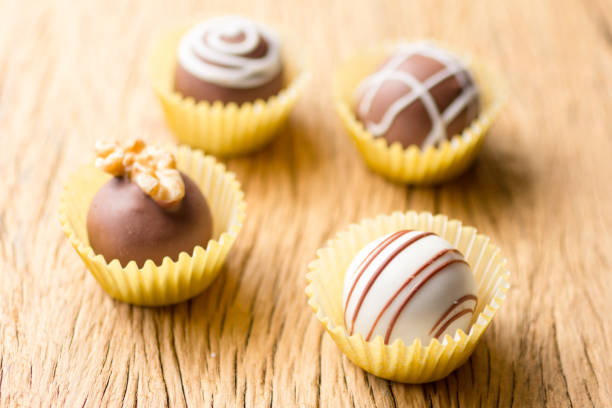 istock Assorted homemade chocolate truffles. Selective focus. Rustic wooden table. 964244960