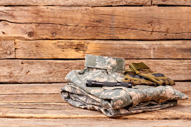 istock Soldiers camouflage outfit with gloves and flashlight. 964246196