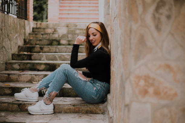 istock Young woman sitting at staircase 964255014