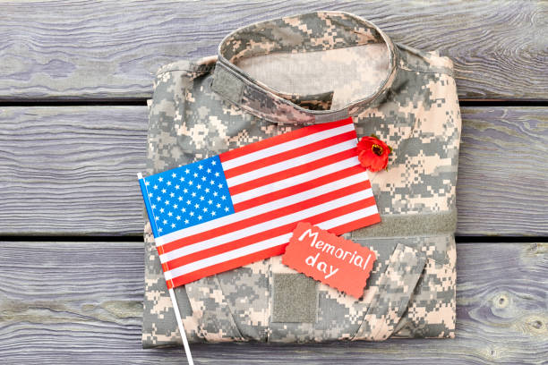 istock Camouflage jacket american flag and red poppy. 964256588