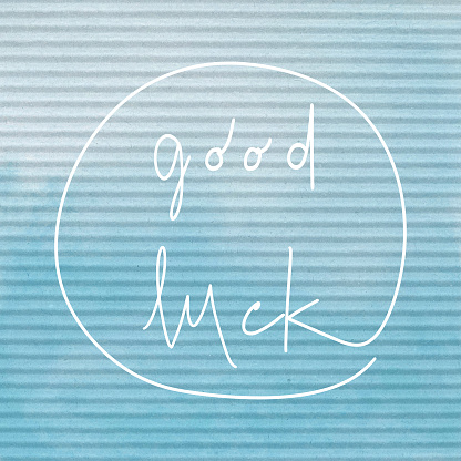 Good Luck. Inspirational quote on blue corrugated paper.