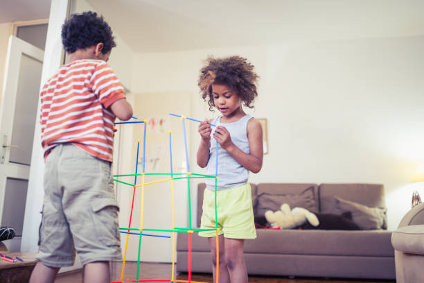 istock Cute mixed - race siblings playing at home 964261336