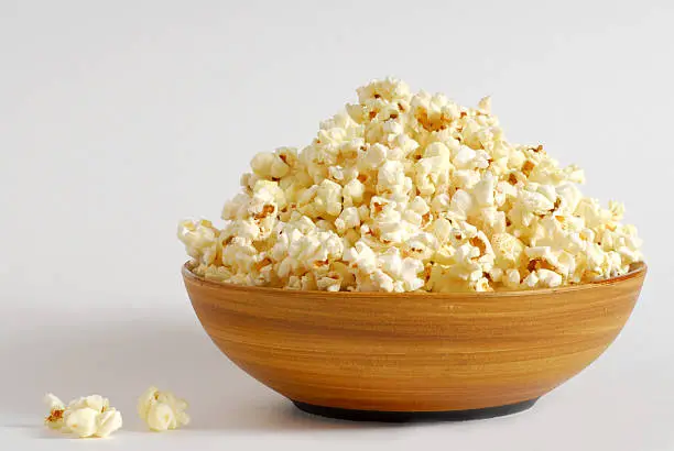 Photo of Wooden bowl filled with popcorn