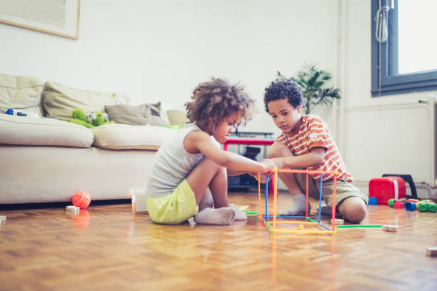 istock Cute mixed - race siblings playing at home 964261474