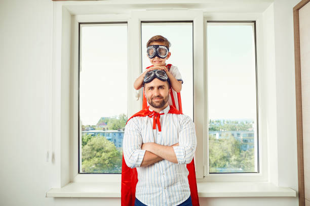 istock Father and son at the window in the room 964267662