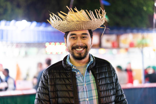 Portrait of a Brazilian man in the Junina Party at night (Festa Junina) - Caipira style Brazilian Junina Party straw hat photos stock pictures, royalty-free photos & images