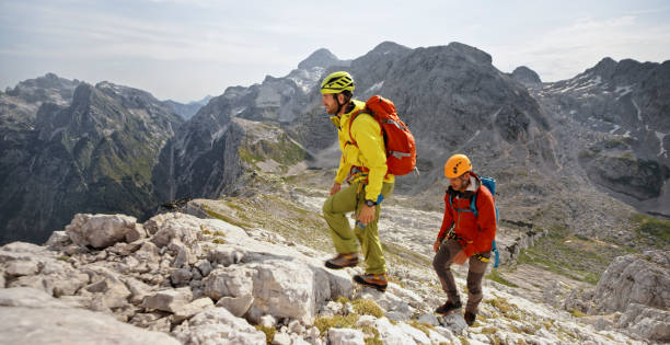 istock Mountaineers walking up on rocky mountain 964273882