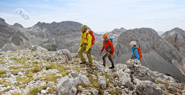 istock Mountaineers walking up on rocky mountain 964273884