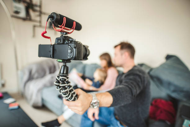 Familly vlogging themselves on the sofa