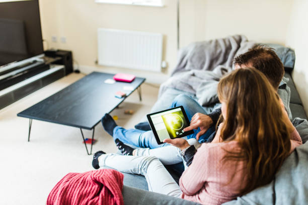 istock Man and woman using digital tablet to set the temperature 964276356