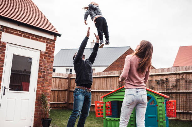 istock Father lifting his daughter in the air playfully 964276424