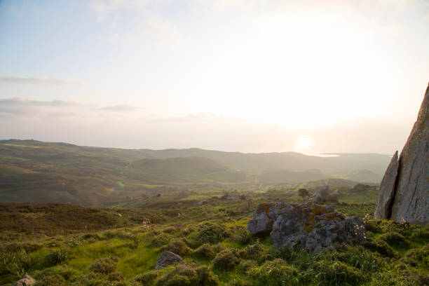 istock View out to distant sea at sunrise, from hills 964276538