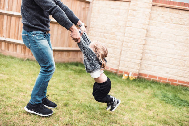 istock Father playfully spinning his daughter 964276574