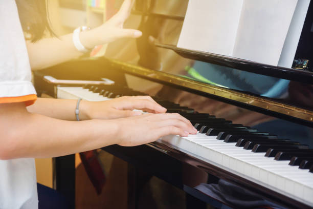 istock Asian young girl practice piano at home 964277304