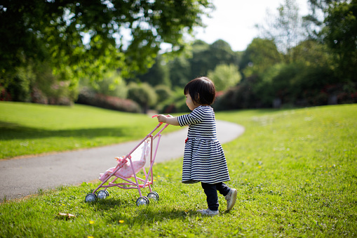 baby girl play at spring forest garden