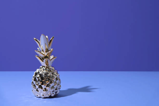 istock Tropical golden Pineapple on ultraviolet background 964277678